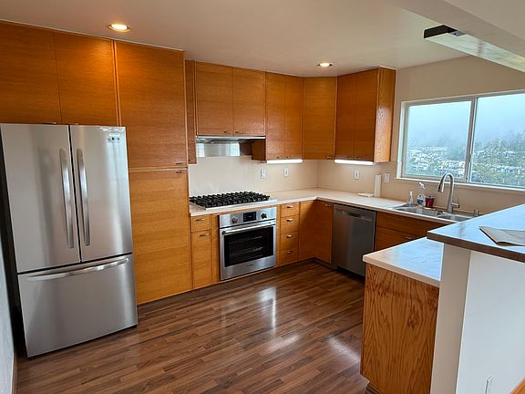 New stainless steel refrigerator and dishwasher now installed. Old fridge moved to garage.