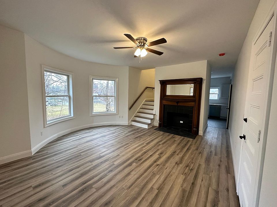 Living room has great light, a very decorative fireplace, brand new staircase & gorgeous bay windows