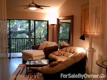 Living Room
						:
						View from the front door. Sheer curtains separate living room and dining area.