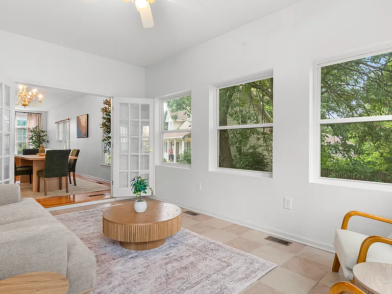 Bright sunroom with comfortable seating and plenty of natural light for relaxing or enjoying morning coffee.