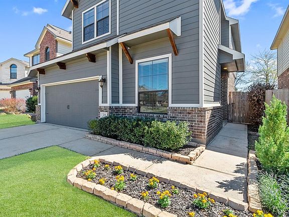 Fantastic curb appeal with lovely landscaping along the walkway to the front door.