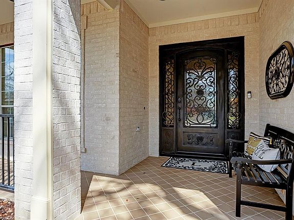 The iron door and side lights make for an outstanding entry. The mostly brick exterior is easy to maintain.