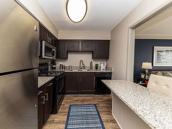 Kitchen with granite counters, stainless appliances, and modern cabinetry