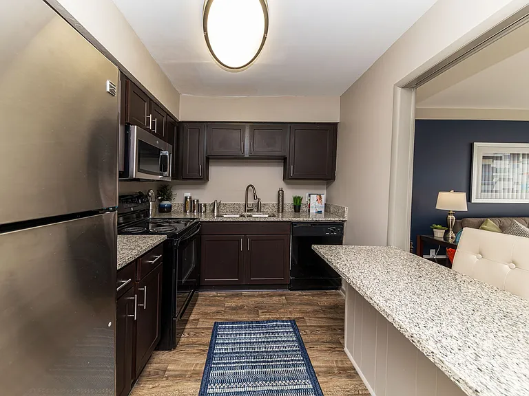 Kitchen with granite counters, stainless appliances, and modern cabinetry