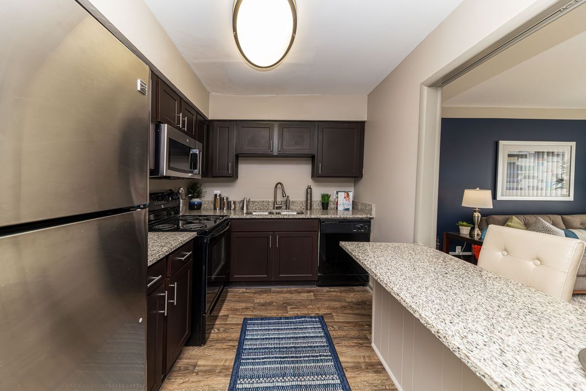 Kitchen with granite counters, stainless appliances, and modern cabinetry