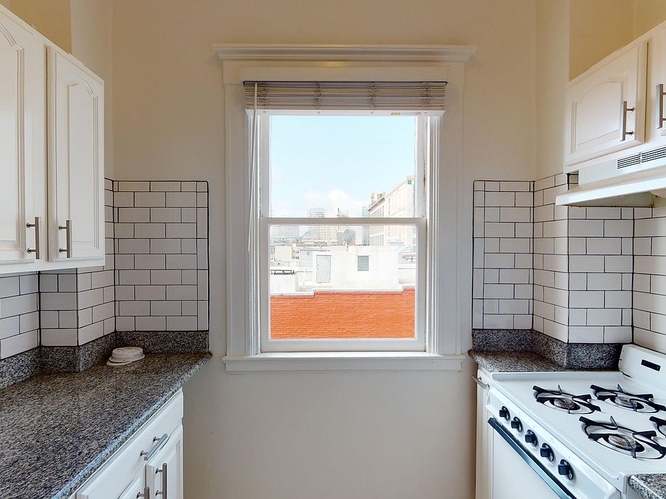 Kitchen with cabinets, stove, and range hood