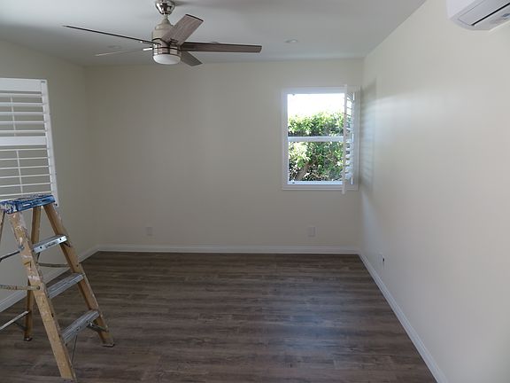 Bright and airy living room with fan and recessed lighting