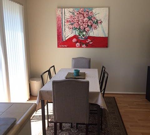 Dining area with balconette at left and sliding door.