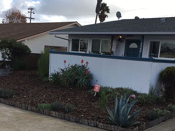 The front yard features drip watering system and low maintenance plants