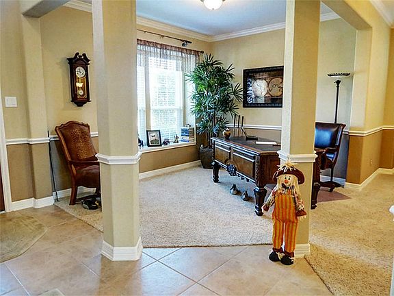 THIS ROOM CAN BE USED AS A STUDY OR FORMAL LIVING ROOM.  CROWN MOLDING, CHAIR RAIL & FRIEZE CARPET. VERY OPEN AND BRIGHT WITH A SMALL WINDOW SEAT.
