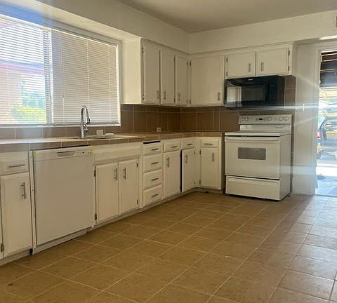 Spacious kitchen new countertop, flooring, faucet built-in microwave, electric range, and new dishwasher