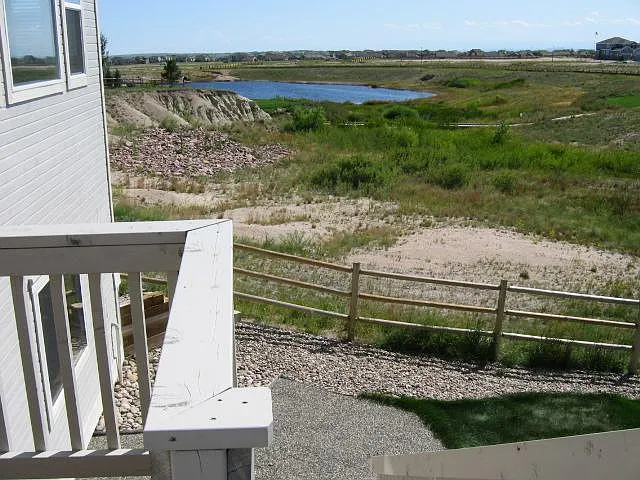 View of the lake. Additional wire rabbit /dog screening has been installed on the fence to secure pets.