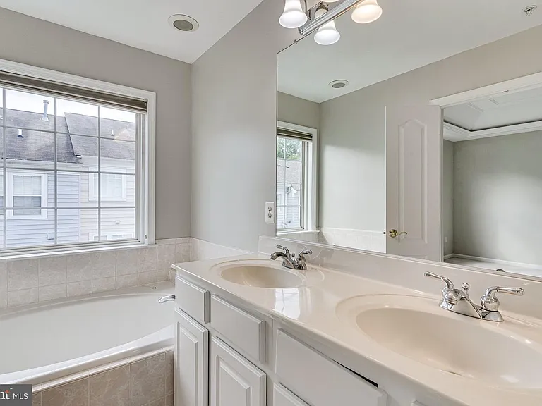 Primary bedroom bathroom
with double sinks vanity, tub and shower.
