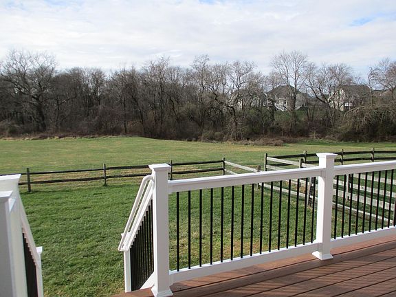 Fenced back yard overlooking open space