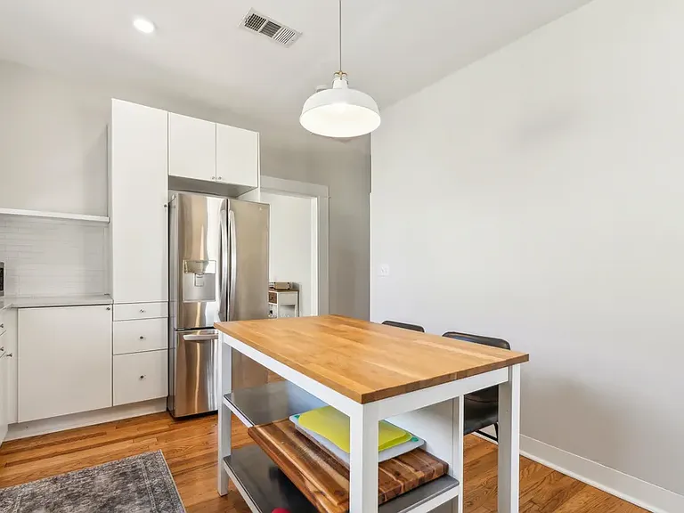 Kitchen with view into dining room and hallway to bedrooms and bathrooms