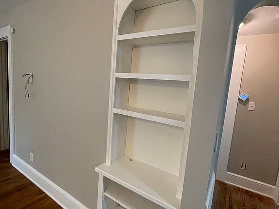 Built in bookshelf adds beauty to the room & has a nook on the bottom shelf that has wires that hook up to the tv mount