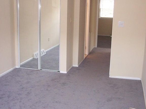 Spacious living room is cable ready with new carpeting.