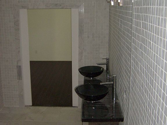 Honed marble walls - Glass vessel sinks