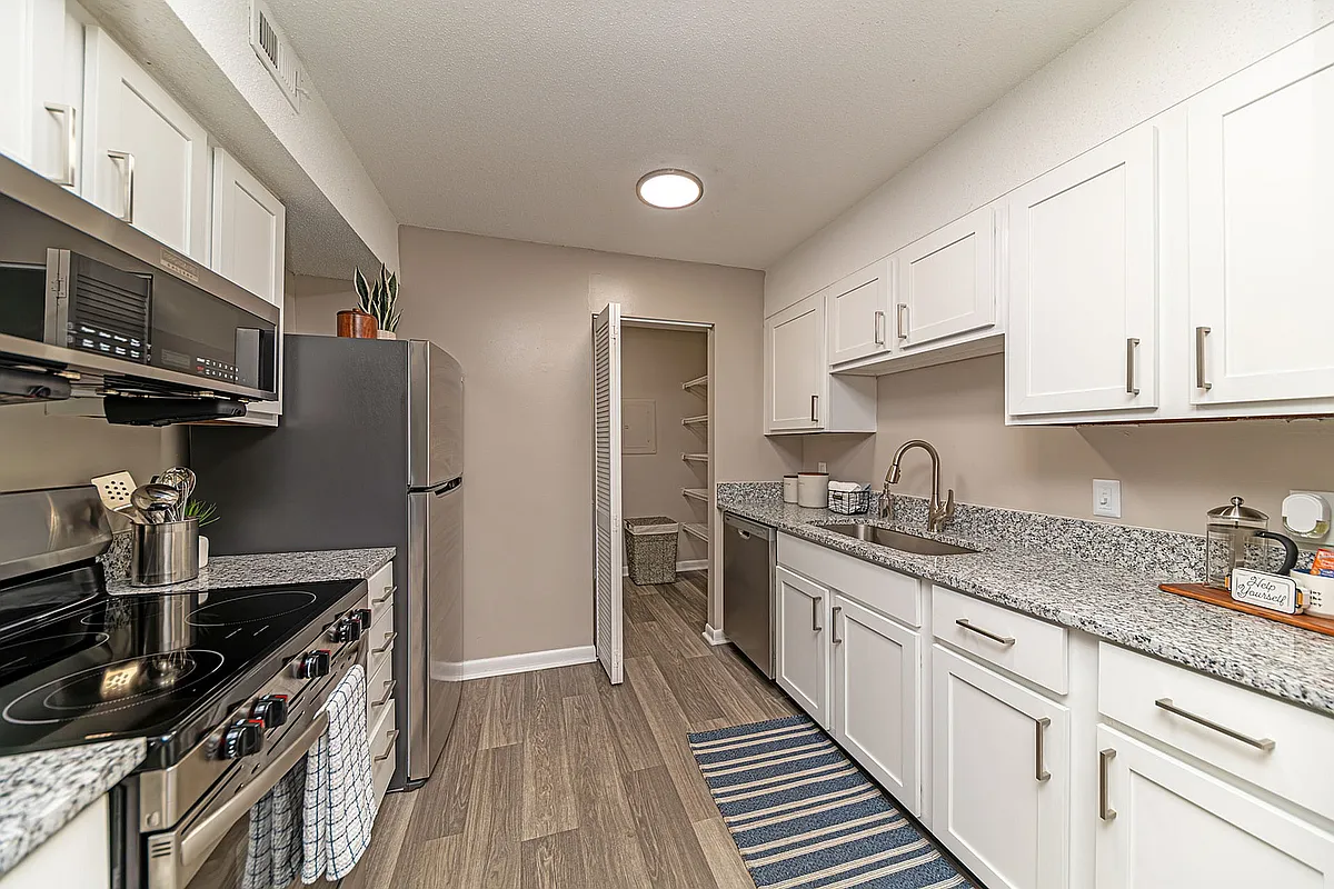 Kitchen with granite counters, stainless appliances, and modern cabinetry - The Artisan West