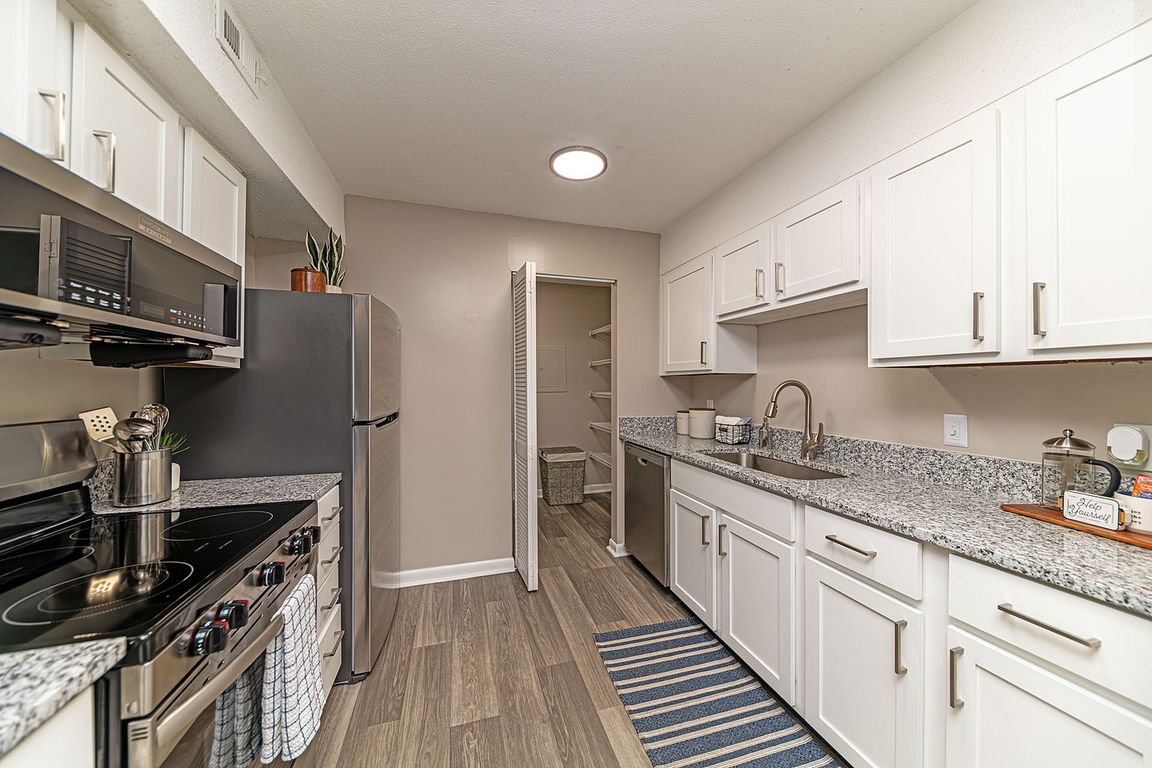 Kitchen with granite counters, stainless appliances, and modern cabinetry