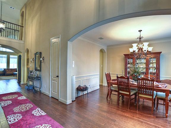Soaring ceilings and architectural detail, Den overlooks Huge covered patio and outdoor kitchen.