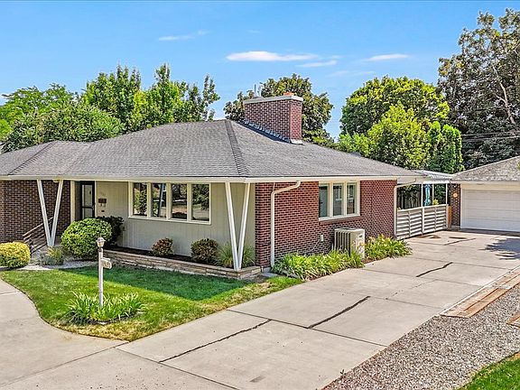 Side Of House With Long Driveway & Two Car Garage