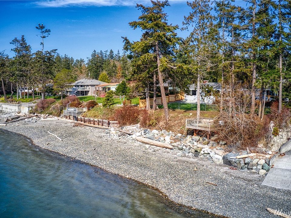 Expansive beach and observation deck as well as main deck near house.  Ramp adjacent is neighbors property.  House is a mere 60' from high tide mark and features 100' of low bank watefront.