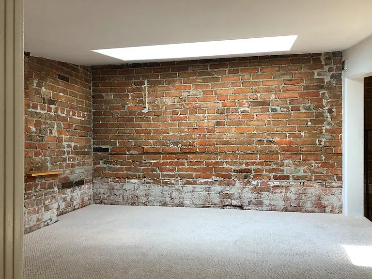 Loft area above living room with skylight which opens and closed using a remote.