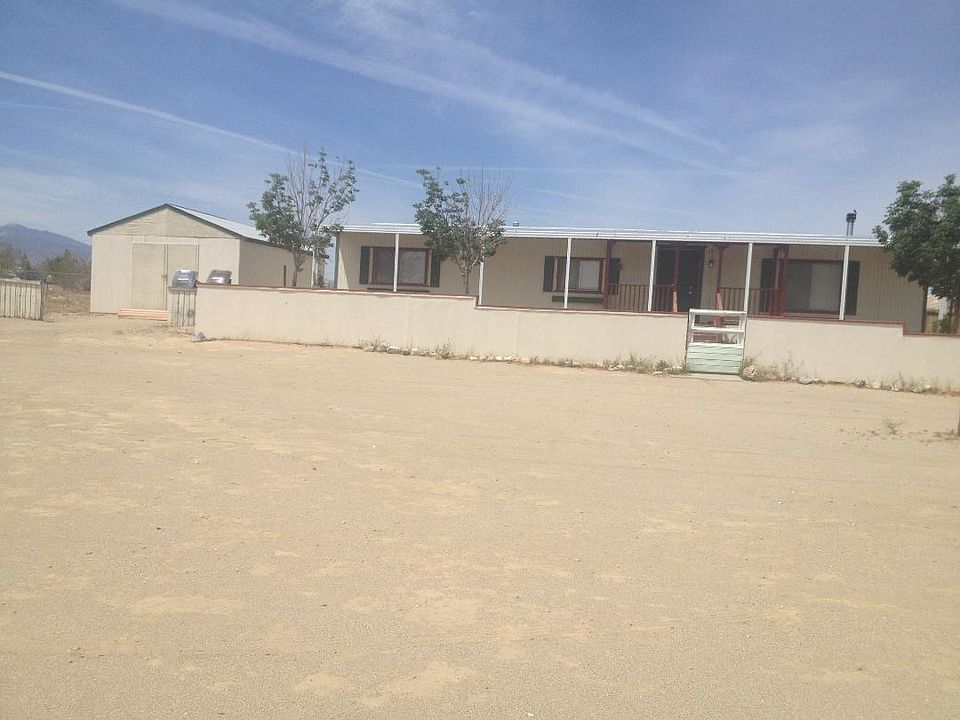 front with gated & large parking area, garage/storage shed