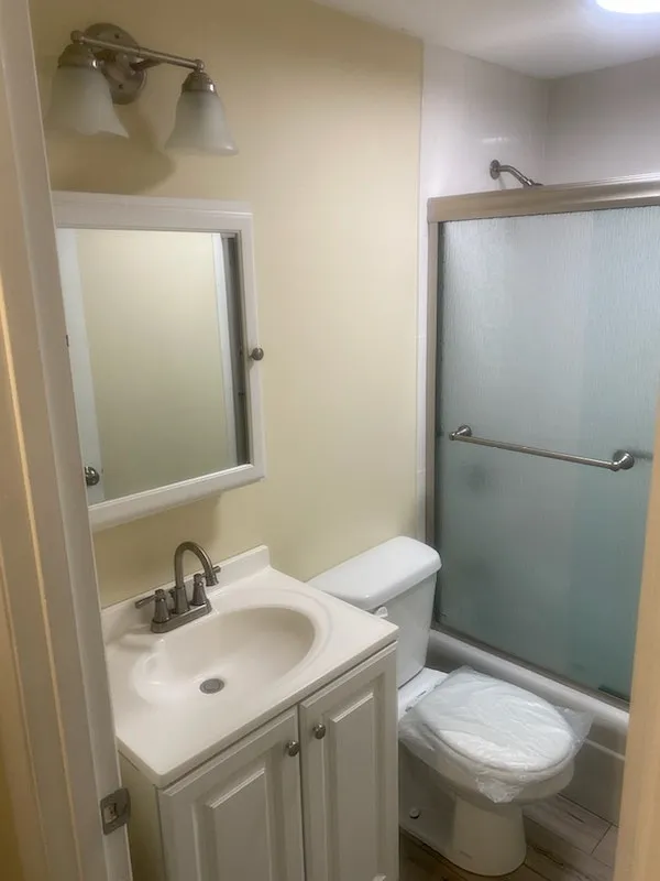 Bath with glass shower/tub enclosure
