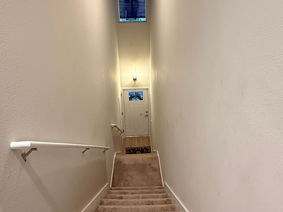 The living area is located upstairs, with a single car garage on the ground floor