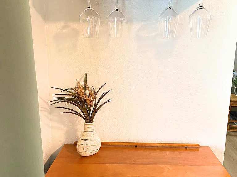 Cozy wine bar in your dining area! It features a stylish wine rack that holds your favorite bottles, paired with a charming wine table for pouring and serving. Perfect for a laid-back evening with friends or a quiet glass to unwind after a long day.