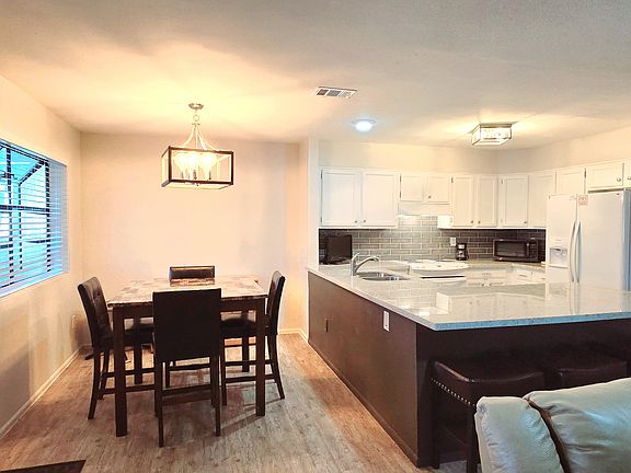 Large dining area with view of covered patio.