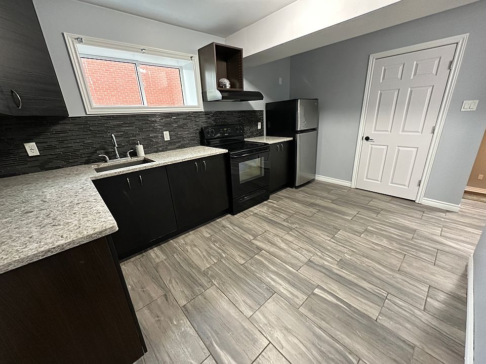 Full open concept kitchen with granite countertops, ample cabinet space and additional storage room.