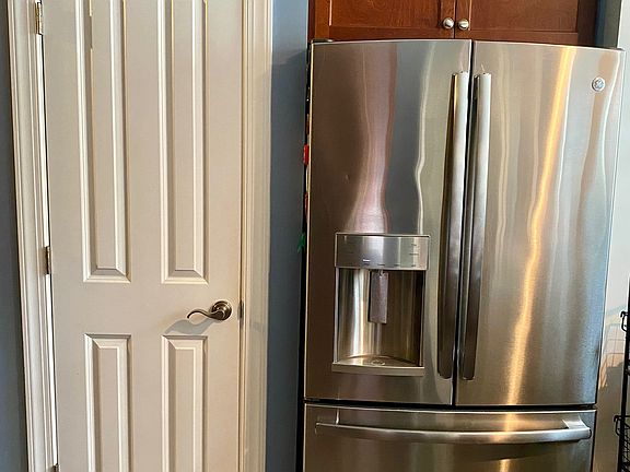 pantry and double door refrigerator in the kitchen