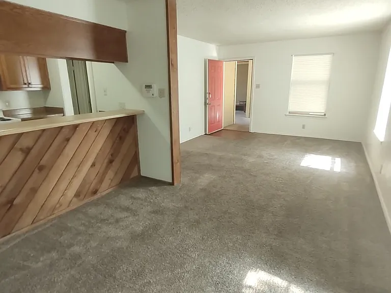Looking from dining area through living area in 2 bedroom apartment