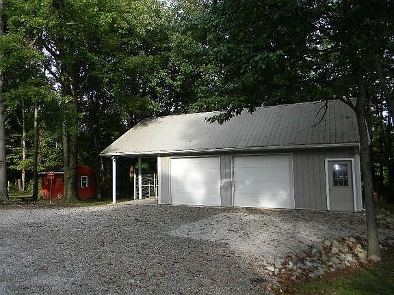 Pole barn with electric, loft storage and carport for RV or Boat.