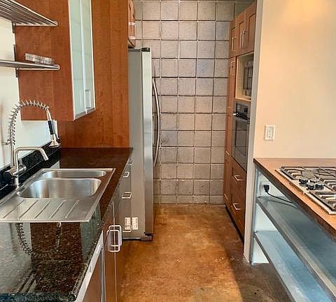 Kitchen with stainless steel appliances (refrigerator, dishwasher, microwave, oven and gas stove), along with plenty of storage.