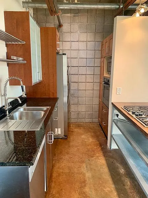 Kitchen with stainless steel appliances (refrigerator, dishwasher, microwave, oven and gas stove), along with plenty of storage.