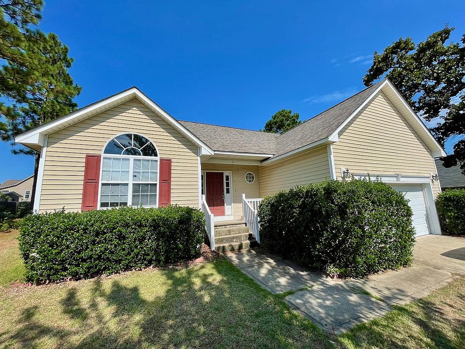 Enter through the front door, or directly into the kitchen through garage. Well kept hedges.