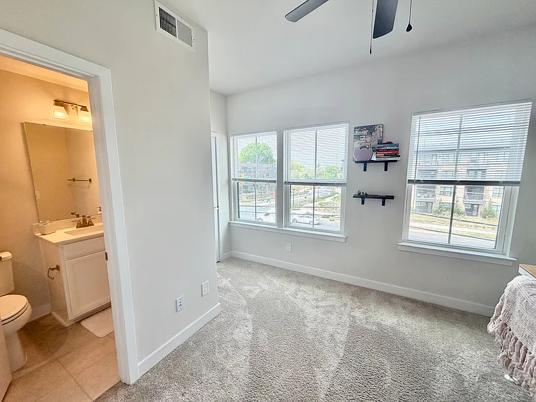 2nd bedroom with natural light, closet and attached full bathroom