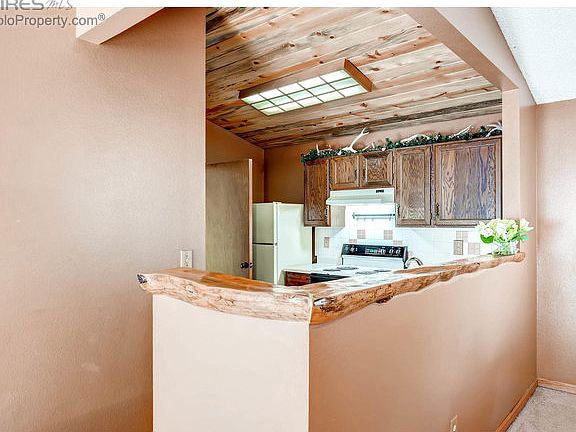 Kitchen w custom bar & wood paneled ceiling