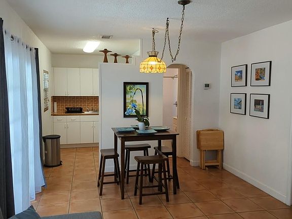 Common area with dining, living room and hallway to bathroom and kitchen