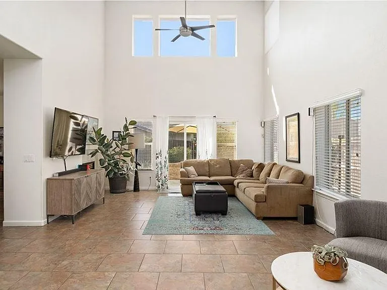 Living room high ceilings - glass door opens for backyard access