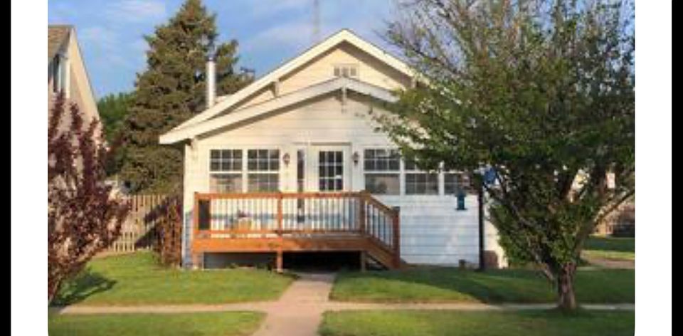 Enclosed front porch with deck.