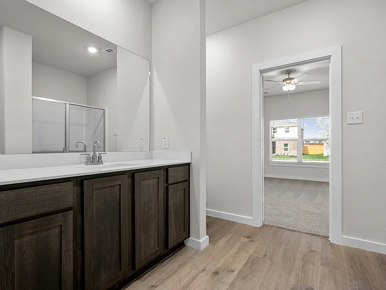 The master bathroom has a sprawling vanity.