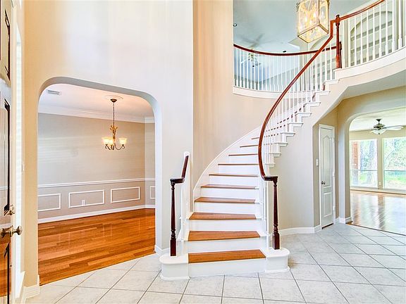 Grand, sweeping staircase greets everyone to this lovely home.