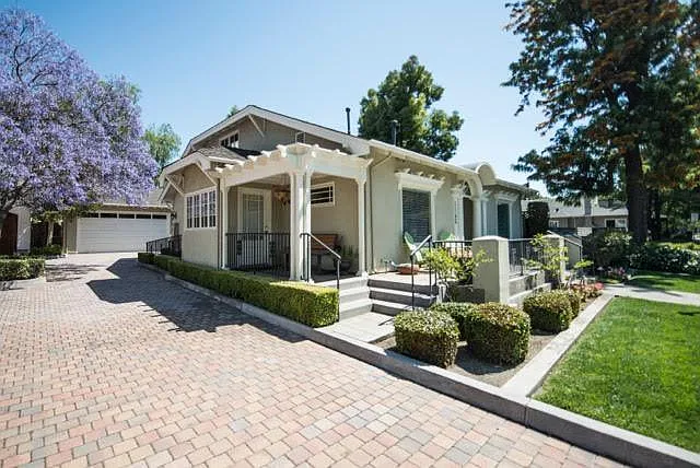 Side entrance with small sitting porch and bench. Also, an extra-long driveway for private parking with an EV charging station for electric vehicles.