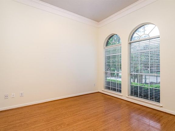 High ceilings, crown molding and arched windows are the classic details that make this room cozy! Use as a study, sitting room o