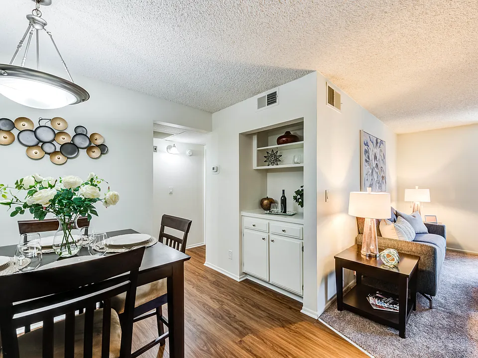 Spacious dining room with plank flooring at the Plaza Apartments